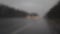 Timelapse autumn rain on car windshield window with road background