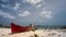 Timelapse of beautiful cloud in tropical island of Belitung Indonesia - Tanjung Kelayang with small wooden boat as foreground