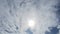 TimeLapse of beautiful sunny blue sky with bright sun light shining through white cloudscape in summer