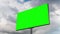 Timelapse - blank green billboard and moving white clouds against blue sky