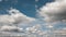 Timelapse of blue sky with white cumulus clouds.