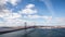 Timelapse of bridge with Tagus river and boats