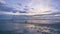 Timelapse :Bright sunset and cloudy over the sea. Dramatic clouds, waves splashes in the beach seaside, beautifully reflective sun