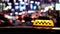 Timelapse of city traffic at night behind taxi sign city Stock Video.
