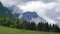 Timelapse of clouds and fog rising from a green forest in Bucegi mountains, part of Carpathians, in Romania. Hiking, trekking.