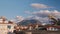 Timelapse of clouds and mountain. Cityscape with sky over mountain. Beautiful clouds flow through city buildings and mountain