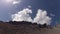 Timelapse of clouds moving on blue skies behind rocks