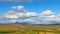 Timelapse of clouds moving over icelandic fields and meadows with river and mountain in sunny day