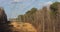 Timelapse clouds moving past row of electricity transmission towers