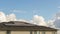Timelapse of clouds over a home with a Solar Panel system installed on roof 4k