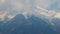 Timelapse of clouds over snowy mountain peaks, Austrian Alps