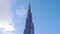 Timelapse of Clouds Running Above The Burj Khalifa among blue sky, tallest building in the world. Dubai, UAE