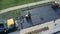 Timelapse. Constructions workers working on road. Asphalt paver applying hot asphalt on the highway. Steamroller flatten