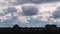 Timelapse of Cumulus Clouds Moves Above the Silhouettes of High-Rise Buildings