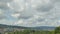 Timelapse cumulus clouds over hills. Fluffy, cotton balls in the sky. View from Hoengg, Zurich