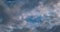 Timelapse of dark blue sky background with many layers tiny stratus cirrus striped clouds. Windy weather