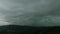 Timelapse dark heavy clouds drift over sky, Barcelona mountains panorama