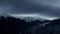 Timelapse of dramatic sky in the winter mountains landscape. Clouds and shadows. Houses in the mountains.