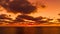 Timelapse Dramatic sunset with fluffy clouds moving in golden burning sky over sea. Abstract aerial nature summer ocean