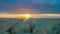 Timelapse of fantastic sunrise over sea. White stones on coast. Luxury resort