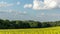 Timelapse of a field where oilseed rape is grown overlooking the surrounding countryside and the landmark of Helfstyn Castle with