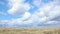 Timelapse floating clouds over a spring field. Dynamic weather