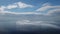 Timelapse of fluffy clouds moving in blue sky over calm sea. Abstract aerial nature summer ocean sunset sea and sky