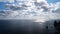 Timelapse of fluffy clouds moving in blue sky over calm sea. Abstract aerial nature summer ocean sunset sea and sky