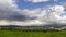 Timelapse follow a rain cloud to the right side moving from the mountains to the city with a gradual rain which passes over