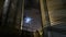 Timelapse of grain terminal at night. Moon and clouds in the sky. Metal tanks of elevator. Grain drying complex