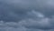 Timelapse grey and white fluffy clouds floating in blue sky