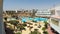Timelapse of hotel resort with blue swimming pool, umbrellas and sunbeds in Egypt