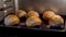 Timelapse - little sesame seed buns baking and rising in electric oven