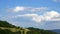 Timelapse - Massive clouds in the distance over the hilly landscape