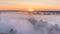 Timelapse mist curling over river and meadow on sunrise background