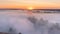 Timelapse mist curling over river and meadow on sunrise background