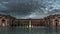 Timelapse monza villa reale with italian flag illuminated and big water garden fountain day to night with cloudy dramatic sky