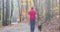 Timelapse motion blurred people on forest trail with fall foliage