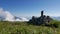 Timelapse on a mountain with clouds rushing by