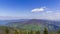 Timelapse of the mountain peaks and the surrounding alpine landscape above which form white clouds changing shape and reflecting l