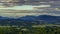 Timelapse of a mountainous natural landscape full of forests and hills with lots of peaks where clouds and shadows move on the lan