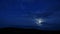 Timelapse: mysterious moon hiding behind clouds, shining brightly in dark sky