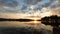 Timelapse of the orange sunset behind the forest in the lake in the spring wide angle of view low key