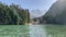 Timelapse. Panoramic scenic view of turquoise mountain lake against the backdrop of trees and mountains