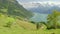 Timelapse panoramic view on small Swiss town surrounded by lake and mountains. Lake Lucerne, Sisikon, Canton Uri, Switzerland