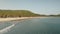 Timelapse of people rest at sand beach, swim at ocean bay aerial. Tropical paradise island