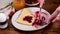 Timelapse of person eating crepes with cherry jam