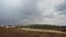 Timelapse Road construction trucks pour graph and sand.