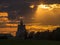 Timelapse with running clouds and sunlight at sunset in the background of a Russian Orthodox Church.