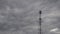 Timelapse. Running gray clouds on the background of the mobile communication tower.